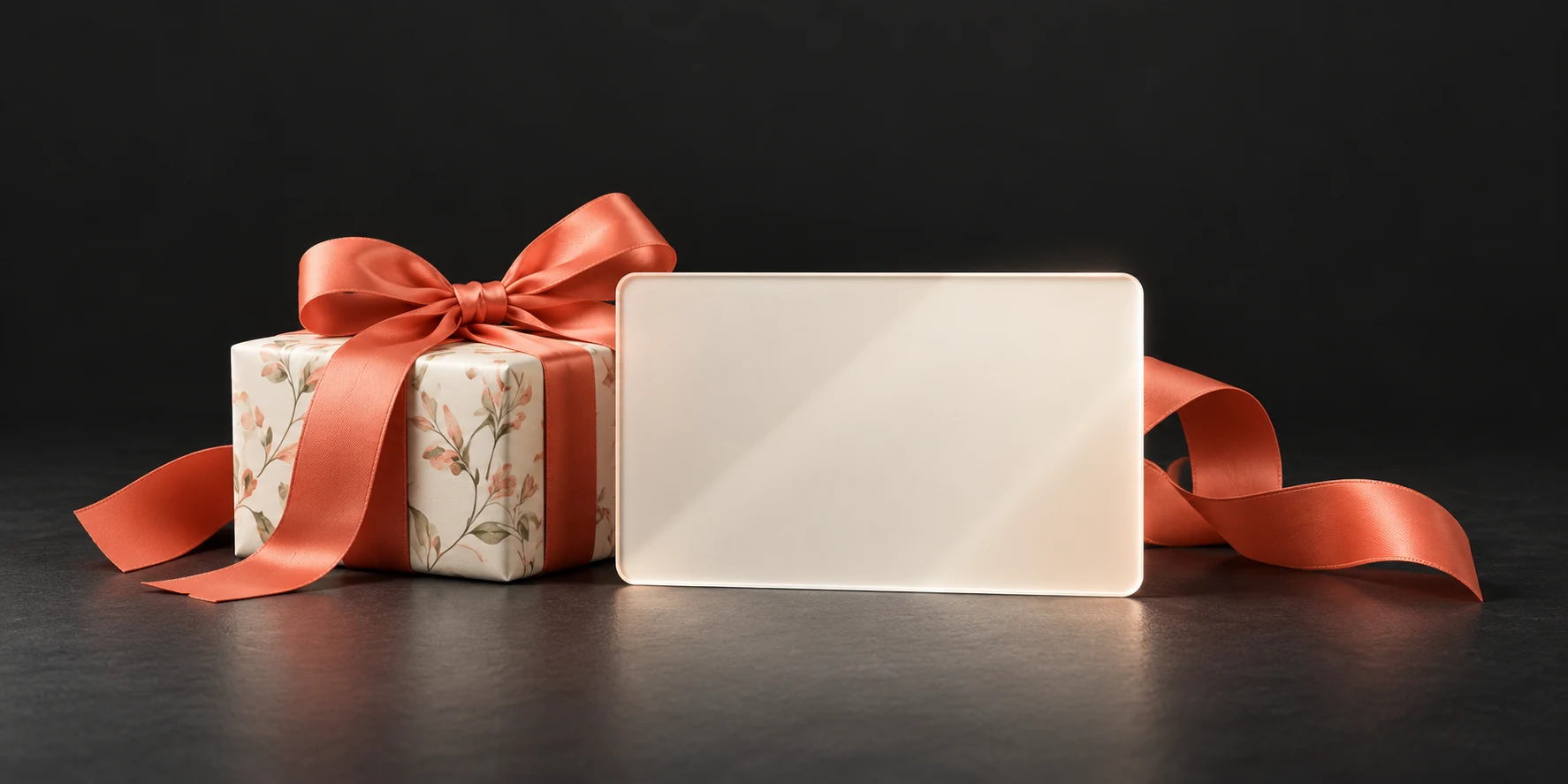 An ivory glass card and a small gift with a coral ribbon, illustrating digital store value